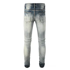 Rear view of slim fit distressed denim jeans with vintage sand wash and double pockets