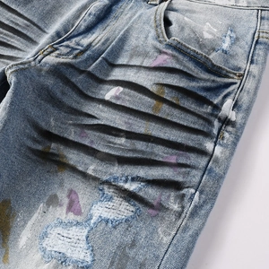Slim fit distressed men's denim jeans with whiskering and colorful paint splatter details