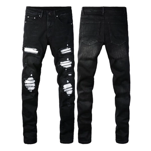 Men's slim fit black distressed jeans with white fabric patches and rip details