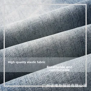 Macro shot of stretch denim fabric showing twill weave texture and washed blue finish