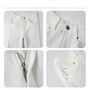 Detail view of white slim straight jeans featuring metal button and reinforced pockets