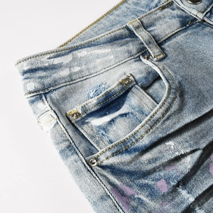 Men's slim stretch jeans with paint splatter graffiti and cat scratch wash effects