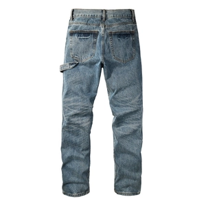 Detail of cargo-style straight-leg jeans with workwear loop and heavy denim texture