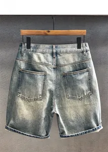 Detailed back view of washed denim shorts featuring large pockets and cuffed hems