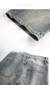 Close-up of light blue washed denim shorts featuring refined stitching and back pocket details