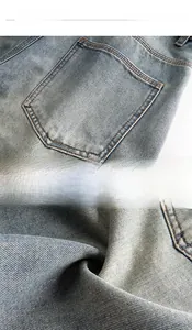 Detail showing high-quality light blue washed denim fabric with reinforced double stitching