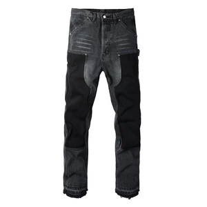 Detail view of heavy denim pants with black patchwork reinforced knees and contrast stitching
