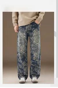 Detailed close-up of light wash denim jeans featuring pixelated fading and cargo stitching