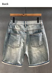 Rear view of vintage light blue washed denim shorts with classic pockets and cuffed hem