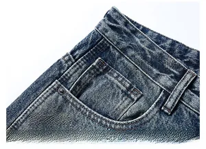 Detail of side pocket and coin pocket on vintage blue washed distressed jeans