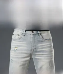 Detail of light blue distressed denim jeans showing cat whiskers and washed texture
