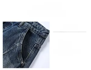 Detail of slim-fit denim jeans featuring a deep blue wash and reinforced metal rivet pockets