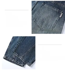 Detailed view of deep blue washed denim jeans featuring minimalist back pockets and hem