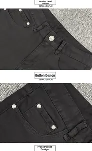 Detail view of black denim jeans showing waist button and reinforced rivets