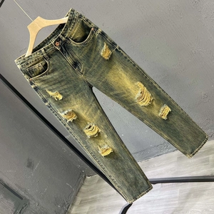 Slim fit light wash distressed jeans for men with vintage yellow-green tint and ripped details