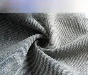 Macro shot of high-quality washed blue cotton denim fabric with twill texture and soft weave