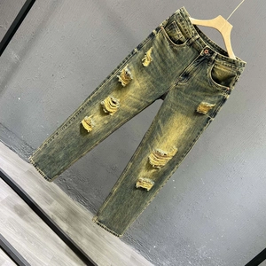 Slim fit vintage washed yellow distressed jeans with ripped details and retro street style