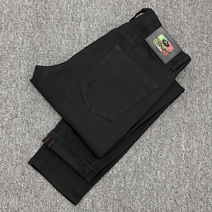 Slim fit men's distressed black denim jeans with leather back label and red selvedge trim