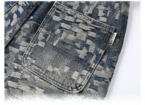 Detailed close-up of blue distressed denim jeans showing jacquard pocket texture and stitching