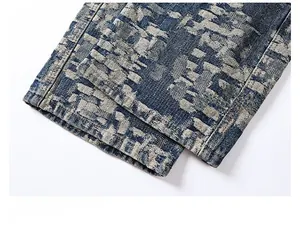 Detail of blue denim trousers featuring a sophisticated houndstooth pattern texture and hem
