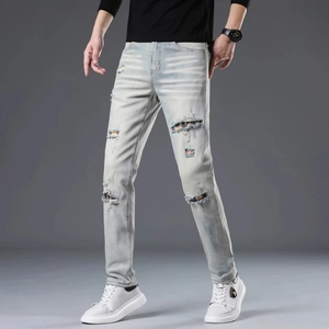 Slim fit light blue ripped jeans for men featuring vintage wash and distressed knee details