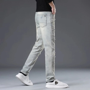Slim fit light blue distressed jeans for men with vintage wash and ripped details