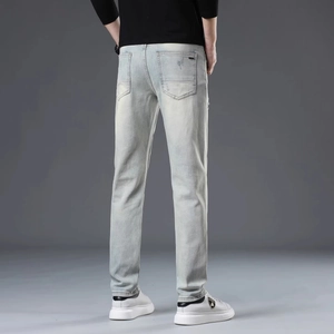 Slim fit men's light blue washed distressed denim jeans with classic back pockets design