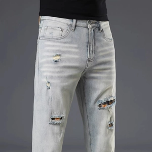 Men's light blue distressed jeans with retro plaid patchwork and vintage washed finish