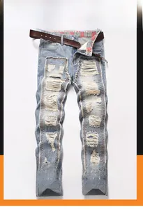 Detailed view of light blue distressed jeans with heavy ripped effects and waist belt detail
