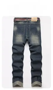 Detail view of retro distressed denim jeans with worn effects and back pocket styling