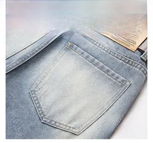 Detail of light blue denim back pocket and brown leather waist patch on vintage jeans