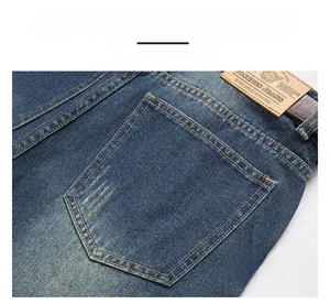 Macro shot of men's distressed denim jeans featuring contrast stitching and leather waist tag