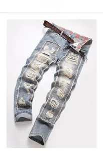 Detail of light blue distressed jeans with frayed holes and plaid lining on waist
