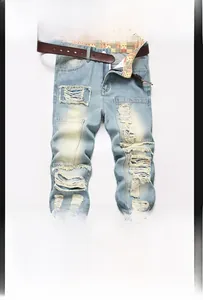 Detail view of light blue ripped jeans showing distressed texture and floral inner lining