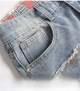 Close-up of front pocket stitching with metal rivets and star-striped inner lining