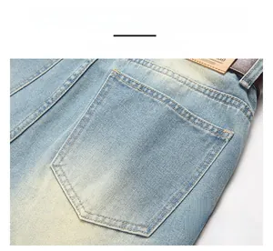 Detail of light blue denim jeans showing back pocket texture and leather waist patch