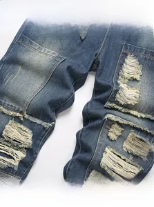 Detailed close-up of distressed denim fabric with ripped holes and retro patchwork