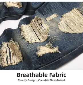Close-up of distressed denim fabric featuring breathable ripped holes and vintage texture