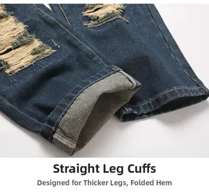 Detail view of straight leg hem with cuffed edges and ripped texture on dark blue denim