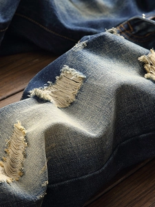Men's vintage distressed straight denim jeans with heavy wash and ripped details