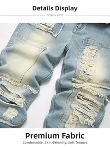 Close-up of light blue distressed jeans with heavy wash and frayed hole textures
