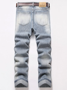 Rear view of men's distressed light blue straight jeans with belt and leather waist patch