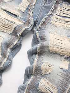 Men's retro distressed straight-leg jeans with heavy ripped details and frayed white tassels