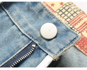Close-up of light blue denim fabric with silver button and American retro pattern lining