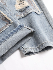 Men's vintage light blue distressed straight jeans with ripped denim texture and patch details
