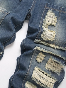 Men's retro blue distressed ripped jeans with vintage patchwork and street punk style detail