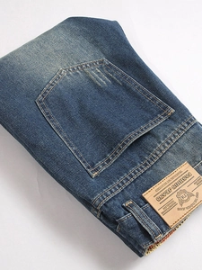 Relaxed fit blue distressed jeans for men with vintage wash and premium leather waist patch