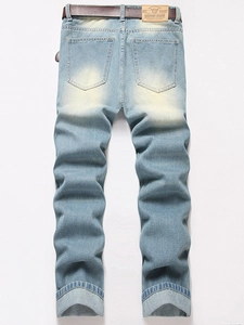 Light blue straight-leg denim jeans for men with brown belt and distressed wash effect