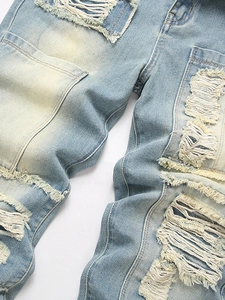 Men's light blue distressed jeans with vintage wash and ripped patchwork details