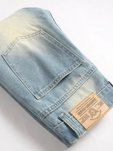 Vintage light blue distressed jeans with leather patch detail and stretch denim texture